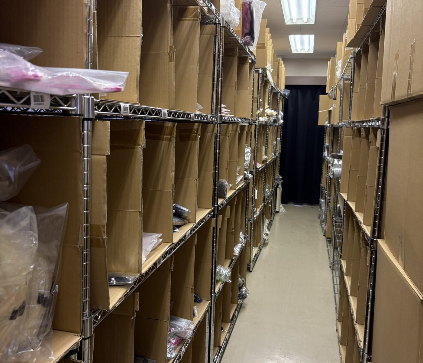 倉庫の通路。両側の棚に商品が収まっている